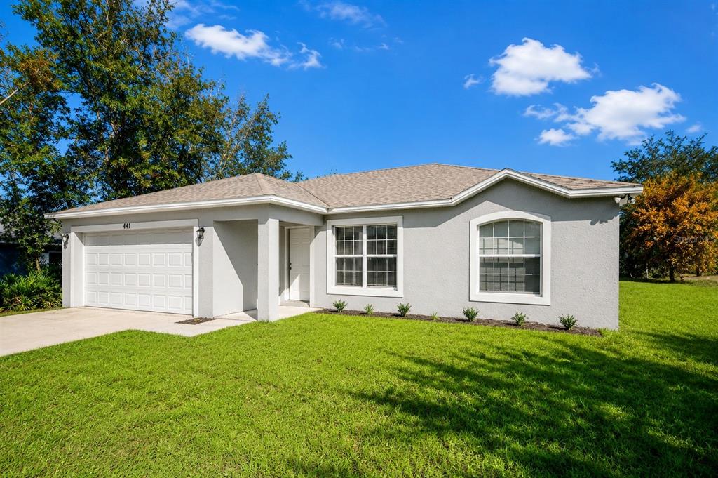 A single-story gray house with a two-car garage and a front lawn — 441 DANUBE DRIVE, KISSIMMEE, FL