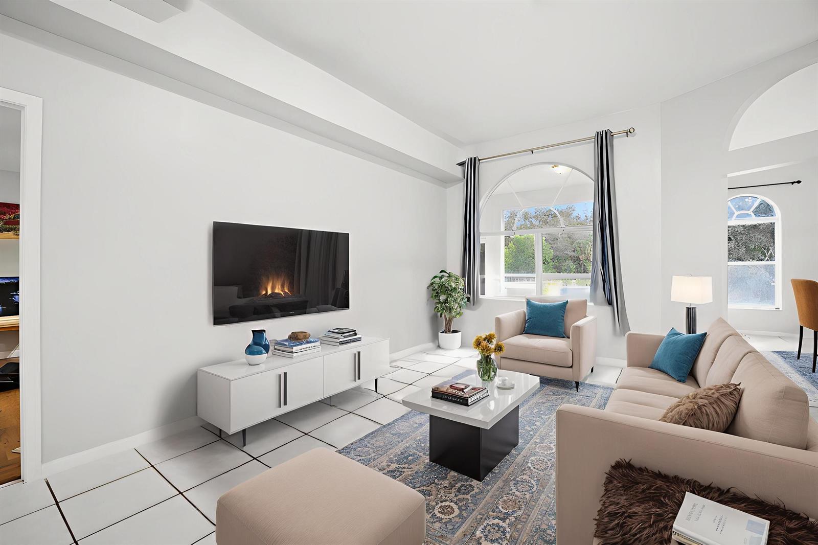 A living room features white tile floors, a wall-mounted television, and a beige sofa — 4584 Windmill Road, FL 33470, FL