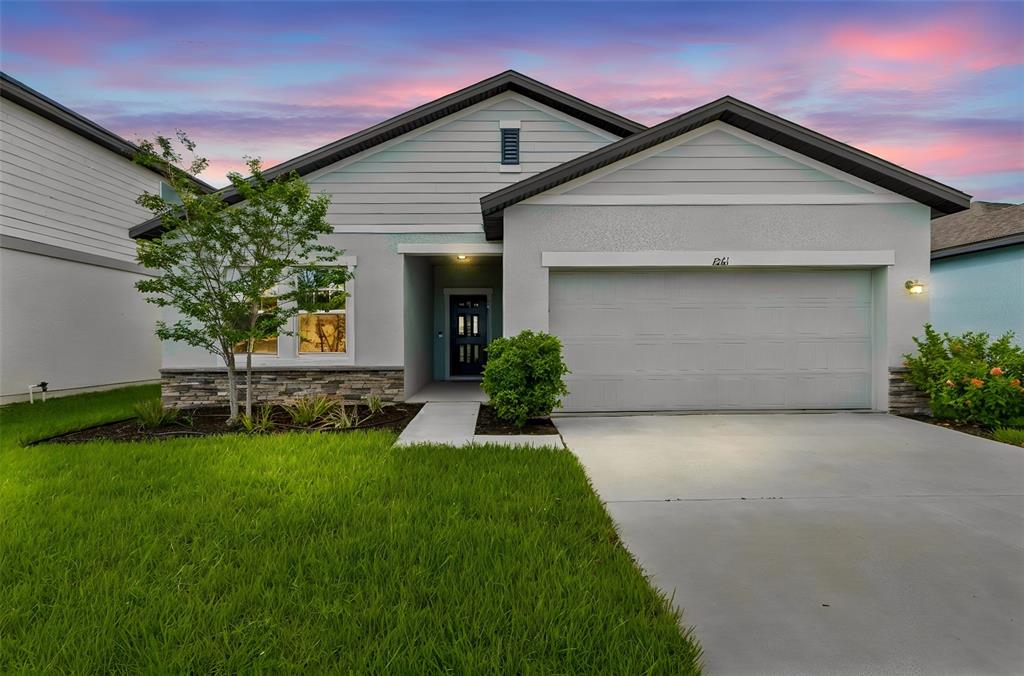 An aerial view of a light blue single-story house with a two-car garage — 1261 ANCHOR BEND DRIVE, RUSKIN, FL