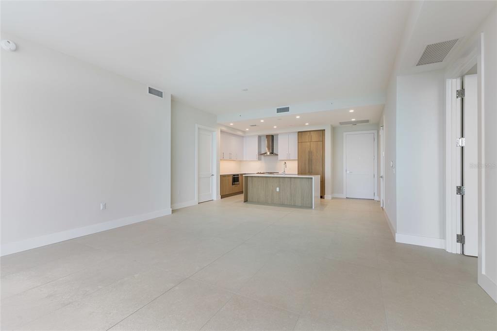 An open-concept kitchen with a central island and light-colored tile flooring — 275 1ST AVENUE S UNIT 3908, ST PETERSBURG, FL