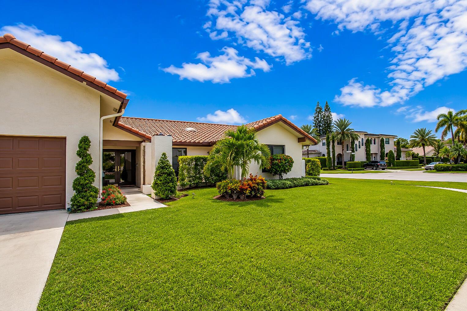 A single-story house with a brown tile roof, garage, and landscaped lawn under a blue sky — 22209 Morning Glory Terrace, Boca Raton FL 33433, BOCA RATON, FL