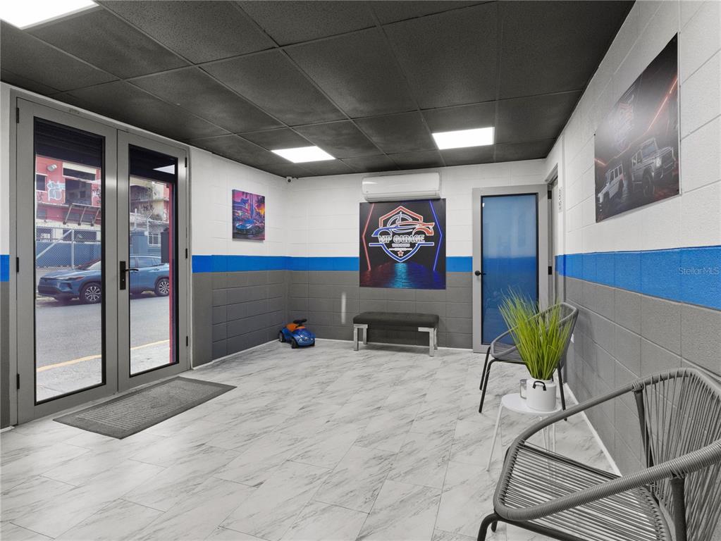 A waiting room features gray and white block walls, marble-look tile flooring, and glass doors — 1195 DEL CARMEN STREET, SAN JUAN, PR