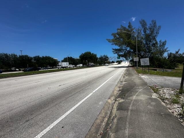 A multi-lane road stretches toward a highway overpass under a clear blue sky — 1430 Southern Boulevard, Glen Ridge FL 33406, GLEN RIDGE, FL