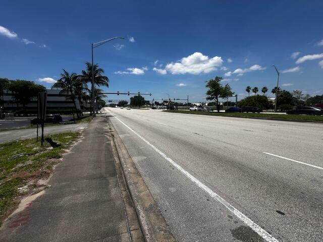 A wide, multi-lane road stretches toward a distant intersection under a bright blue sky — 1430 Southern Boulevard, Glen Ridge FL 33406, GLEN RIDGE, FL