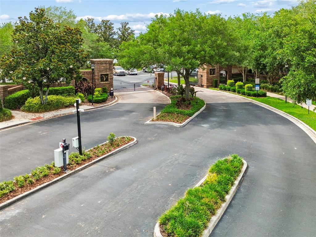 An elevated view of a gated community entrance with paved roads and landscaped islands — 4423 BARNSTEAD DR, RIVERVIEW, FL