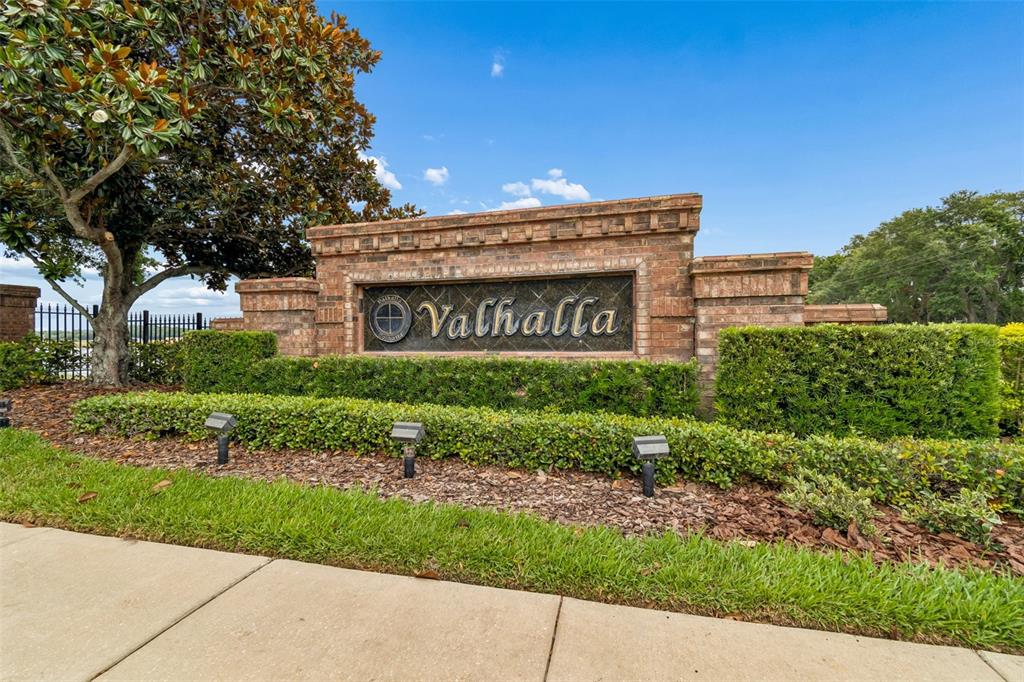 A brick monument sign for Valhalla stands behind a manicured hedge and lawn — 4423 BARNSTEAD DR, RIVERVIEW, FL