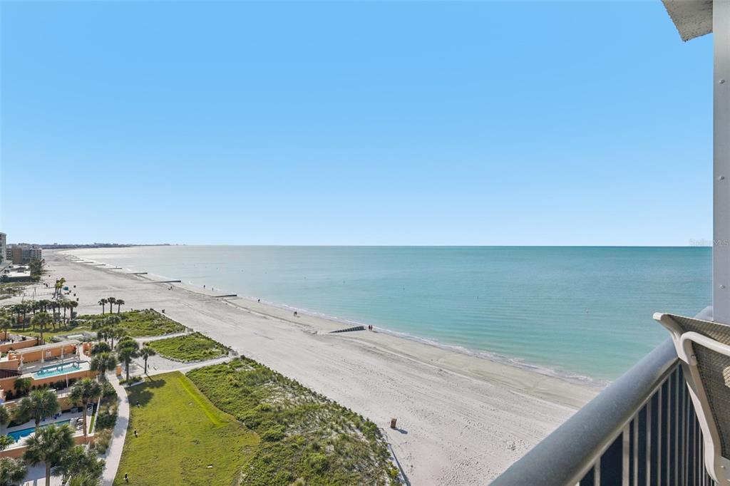 A high-angle view of a sandy beach and ocean from a balcony — 15316 GULF BOULEVARD UNIT 801, MADEIRA BEACH, FL