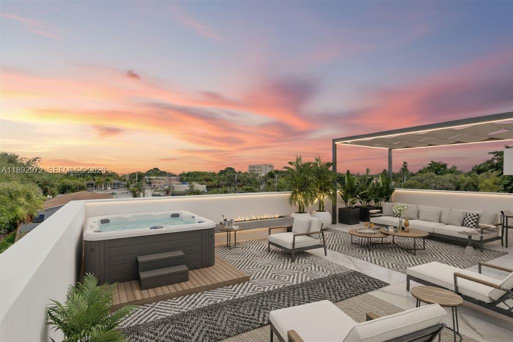 A modern three-story townhouse with a gated entrance, palm trees, and a for-sale sign — 503 NE 61st St, Miami FL 33137, MIAMI, FL