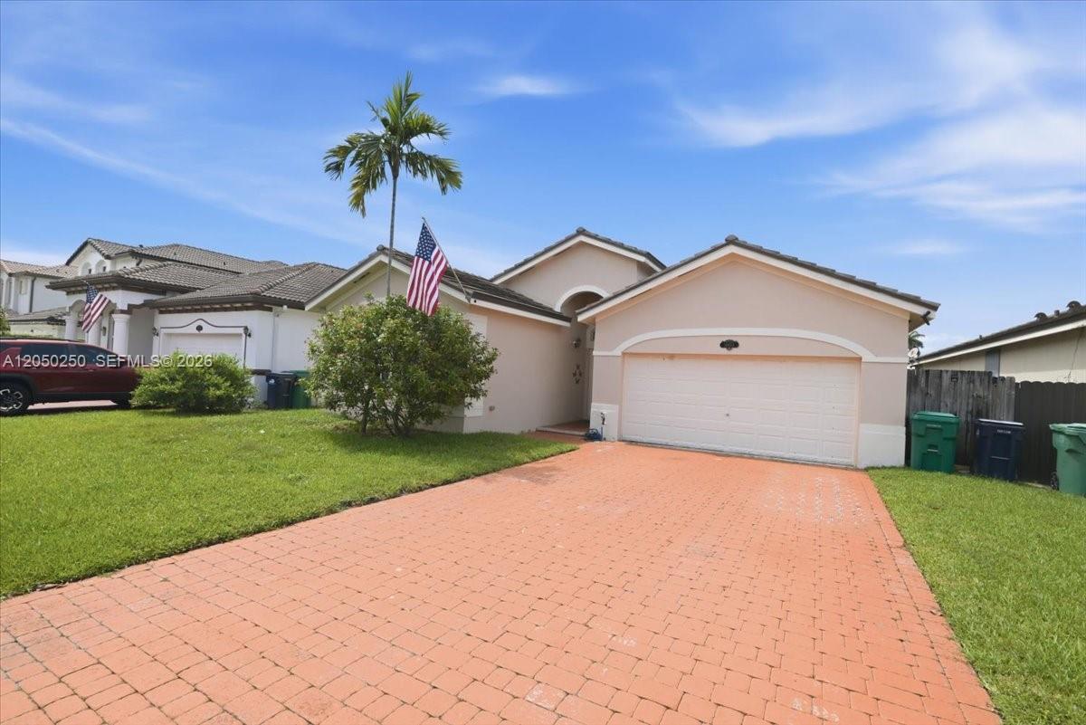 A single-story house with a brick driveway, a two-car garage, and a palm tree — 14623 SW 11th St, Miami FL 33184, MIAMI, FL