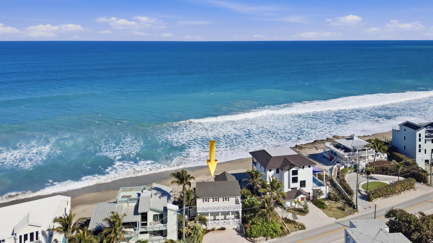 An aerial view shows a beachfront house marked with a yellow arrow near the ocean — 1031 SE Macarthur Boulevard, Stuart FL 34996, STUART, FL