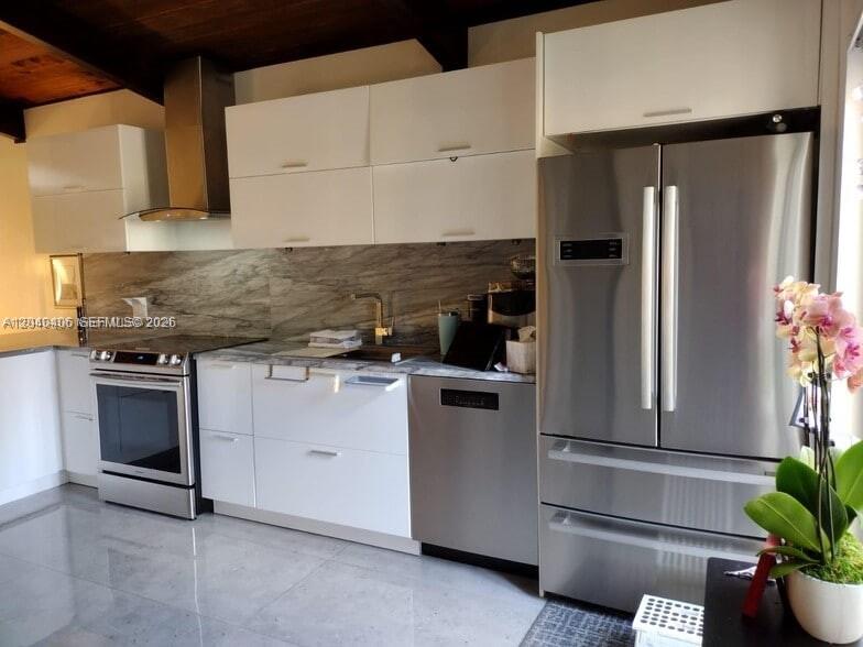 A modern kitchen features white cabinets, stainless steel appliances, and a marble-patterned backsplash — 112 Fox Rd # 50, Hollywood FL 33024, HOLLYWOOD, FL