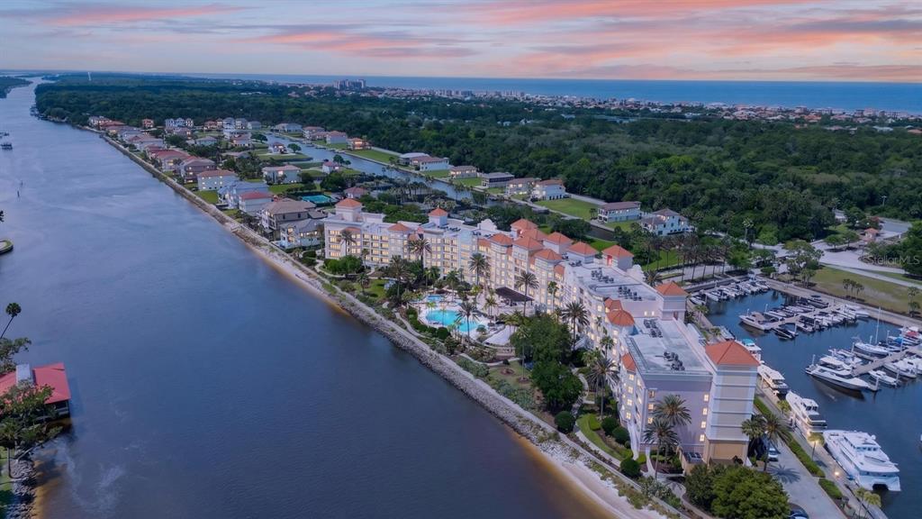 An aerial view of a waterfront condominium complex with a pool and boat slips — 102 YACHT HARBOR DRIVE UNIT 378, PALM COAST, FL