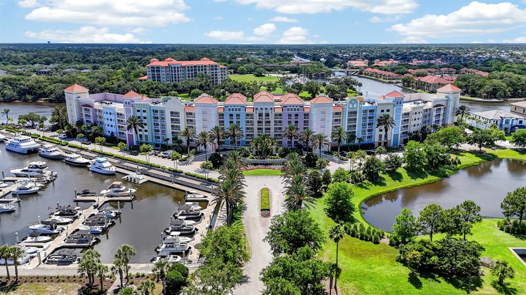 An aerial view shows a large, colorful resort complex situated along a marina and waterway — 102 YACHT HARBOR DRIVE UNIT 378, PALM COAST, FL