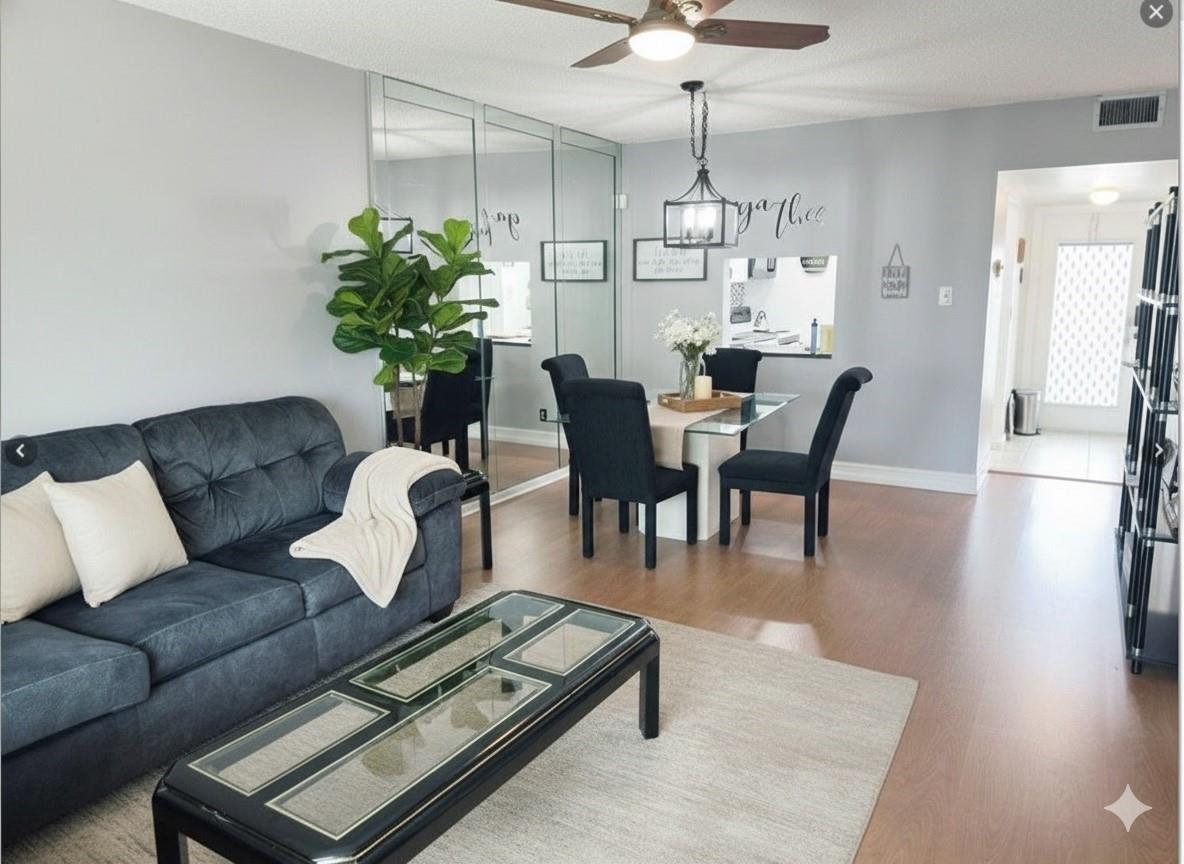 A living and dining area features a grey sofa, glass coffee table, and mirrored wall — 7505 NW 5th Place # 203, Margate FL 33063, MARGATE, FL