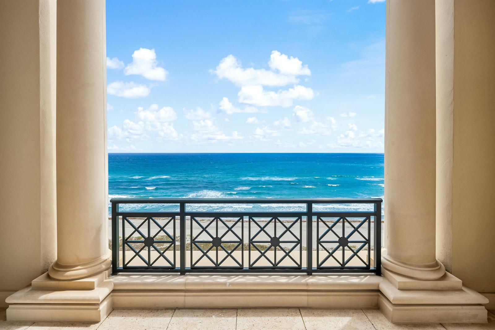A balcony with stone columns and a black metal railing overlooks the blue ocean — 2500 S Ocean Boulevard # 903, Boca Raton FL 33432, BOCA RATON, FL