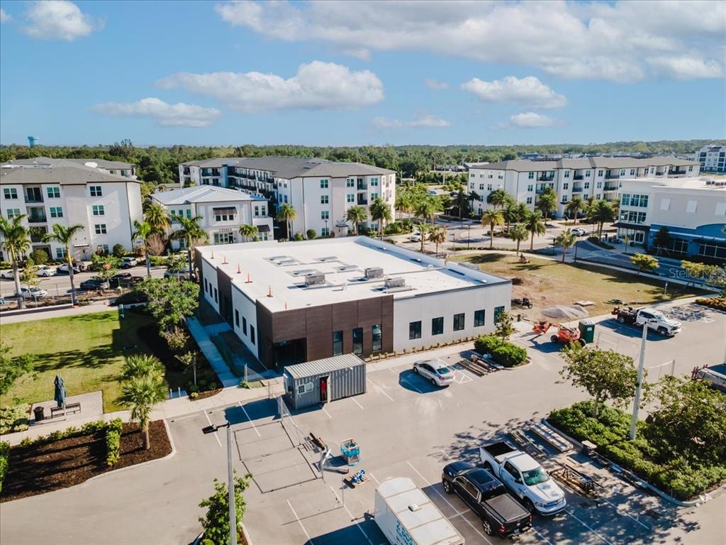 An unfinished commercial interior features bare concrete floors, drywall-covered walls, and an exposed ceiling structure — 6355 INITIATIVE BOULEVARD UNIT 110, SARASOTA, FL