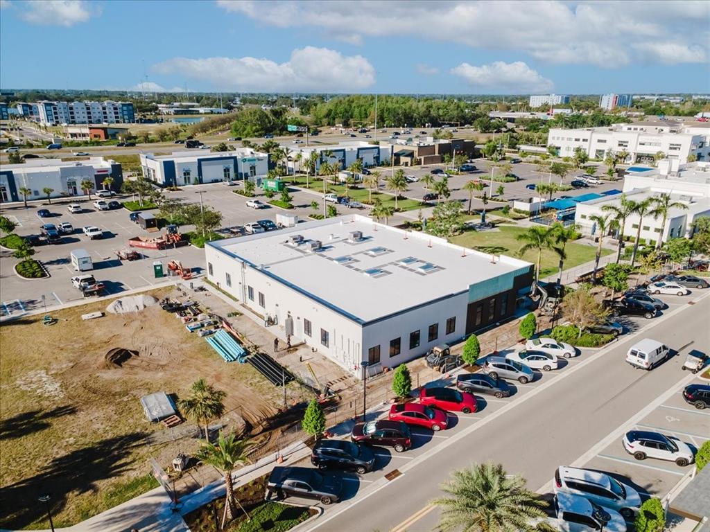An unfinished commercial interior features bare concrete floors and walls with exposed drywall seams — 6355 INITIATIVE BOULEVARD UNIT 110, SARASOTA, FL