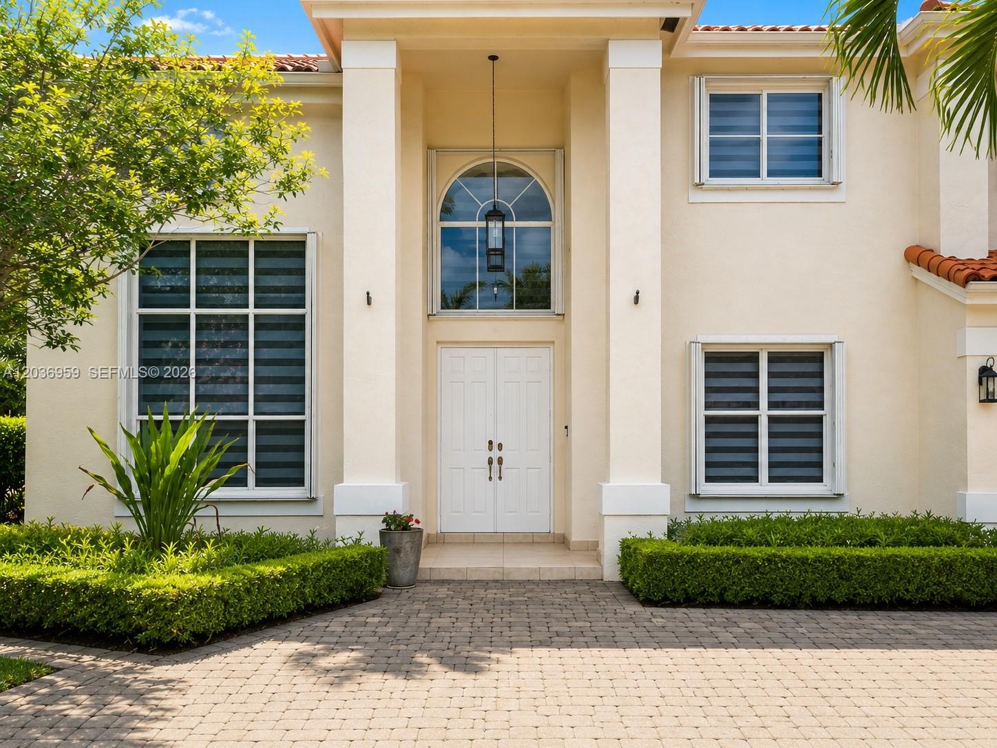 A two-story house with a beige stucco exterior, tiled roof, and a paved circular driveway — 4221 SW 154th Pl, Miami FL 33185, MIAMI, FL