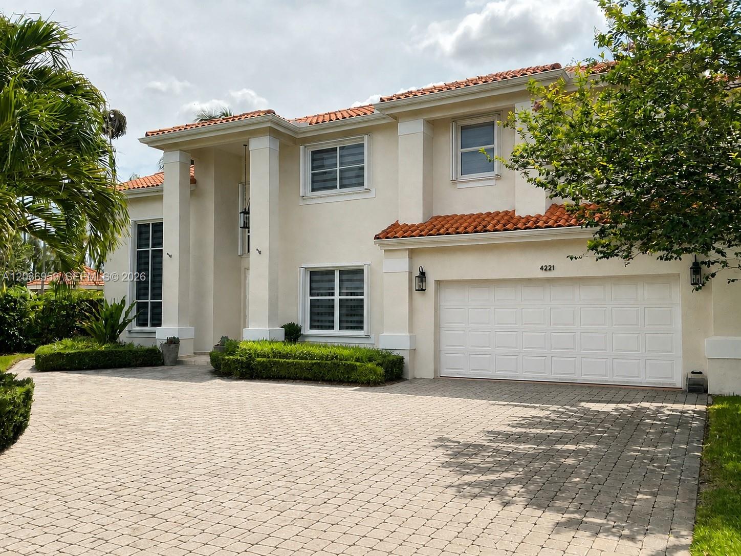 The exterior of a two-story house features a white double door entrance and columns — 4221 SW 154th Pl, Miami FL 33185, MIAMI, FL