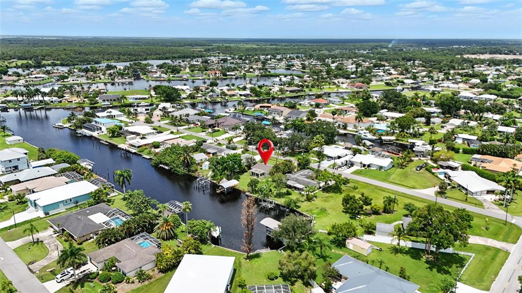 An aerial view shows a waterfront house marked with a red pin on a canal — 2131 SAINT CROIX AVENUE, FORT MYERS, FL