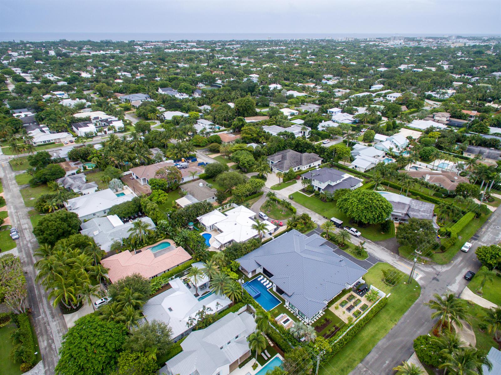 An aerial view of a suburban neighborhood featuring houses with swimming pools and lush landscaping — 322 NW 16th Street, Delray Beach FL 33444, DELRAY BEACH, FL