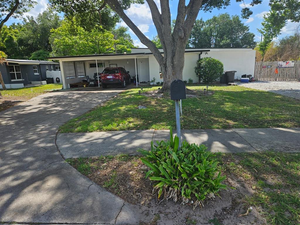 A single-story house with a carport, a large tree in the front yard, and a mailbox — 2800 S FRENCH AVENUE, SANFORD, FL