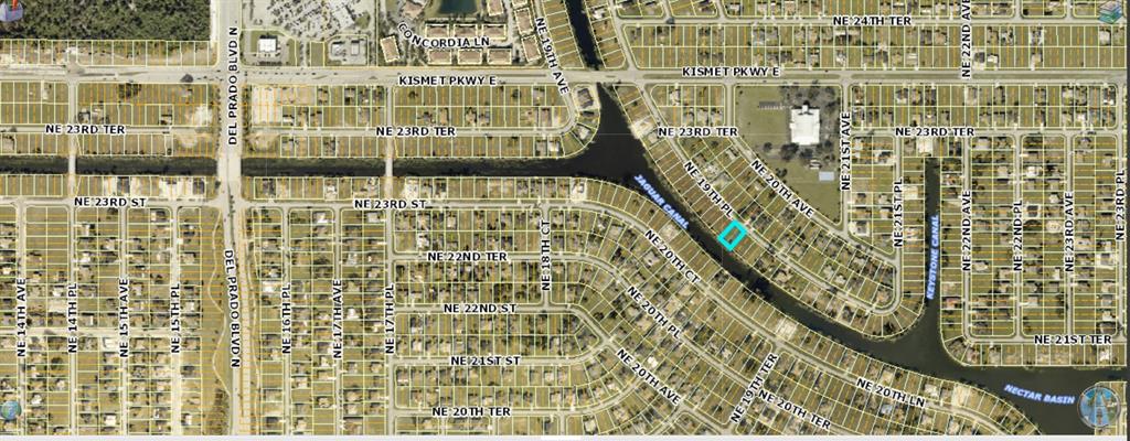 This aerial map shows a residential lot highlighted in blue along a canal — 2216 NE 19TH PLACE, CAPE CORAL, FL
