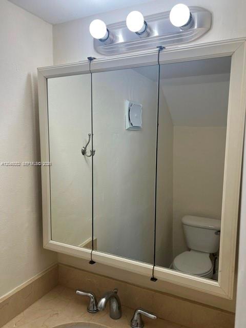 A bathroom vanity features a three-panel medicine cabinet mirror above a sink faucet — 7626 NE 6th Ct # 5, Miami FL 33138, MIAMI, FL