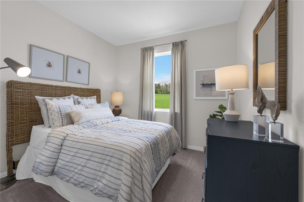 A bedroom features a woven headboard, a striped bedspread, a dark dresser, and a window — 6767 WINTERBERRY DRIVE, LAKE HAMILTON, FL
