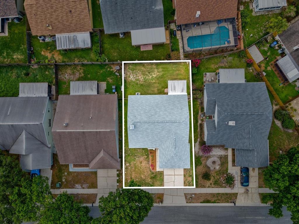 An aerial view shows a single-story house with a gray roof on a residential lot — 1105 TUXFORD DRIVE, BRANDON, FL