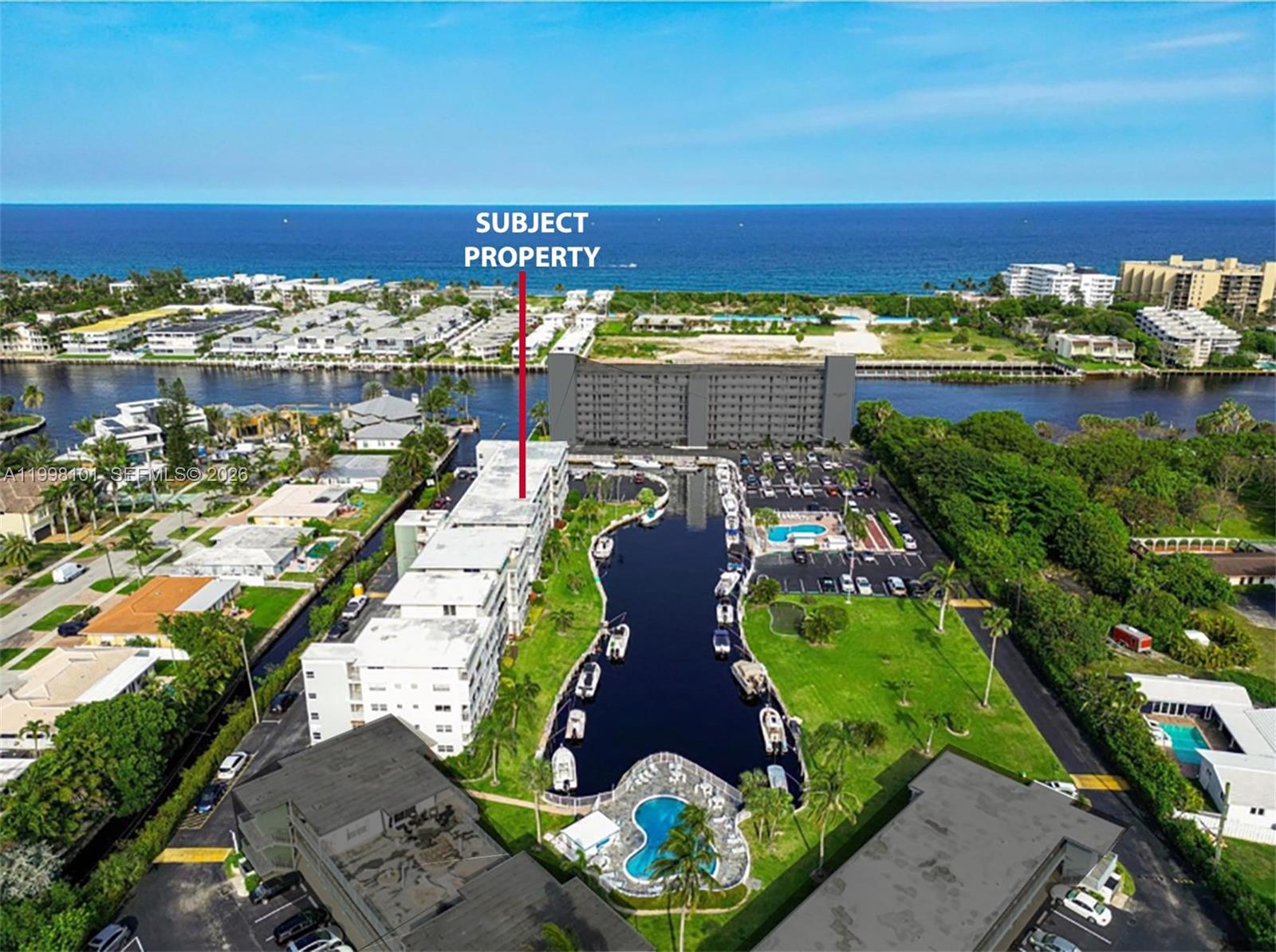 An aerial view shows a multi-story apartment building with a marina and swimming pool — 1511 SE 15th Ct # 403, Deerfield Beach FL 33441, DEERFIELD BEACH, FL
