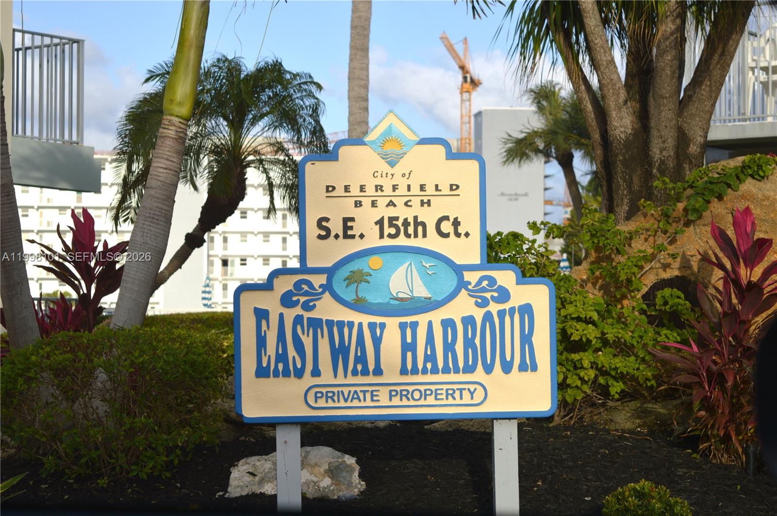 A sign for Eastway Harbour stands in a landscaped area with palm trees and buildings — 1511 SE 15th Ct # 403, Deerfield Beach FL 33441, DEERFIELD BEACH, FL