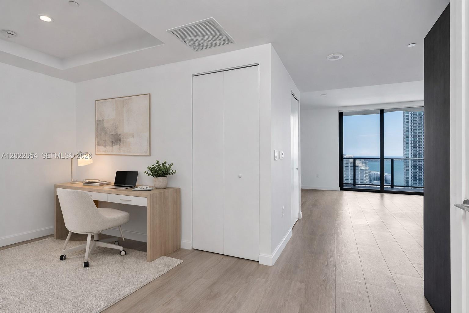 A home office area features a light wood desk, white chair, and closet near a window — 45 SW 9th St # 3502, Miami FL 33130, MIAMI, FL