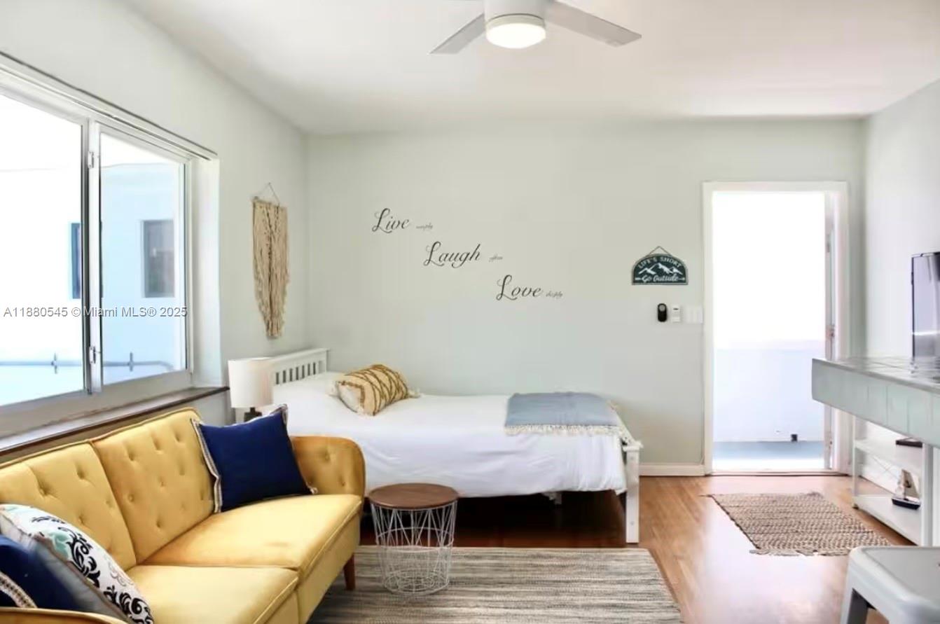 A studio apartment features a yellow sofa, a single bed, and a ceiling fan — 316 Walnut St # 2, Hollywood FL 33019, HOLLYWOOD, FL