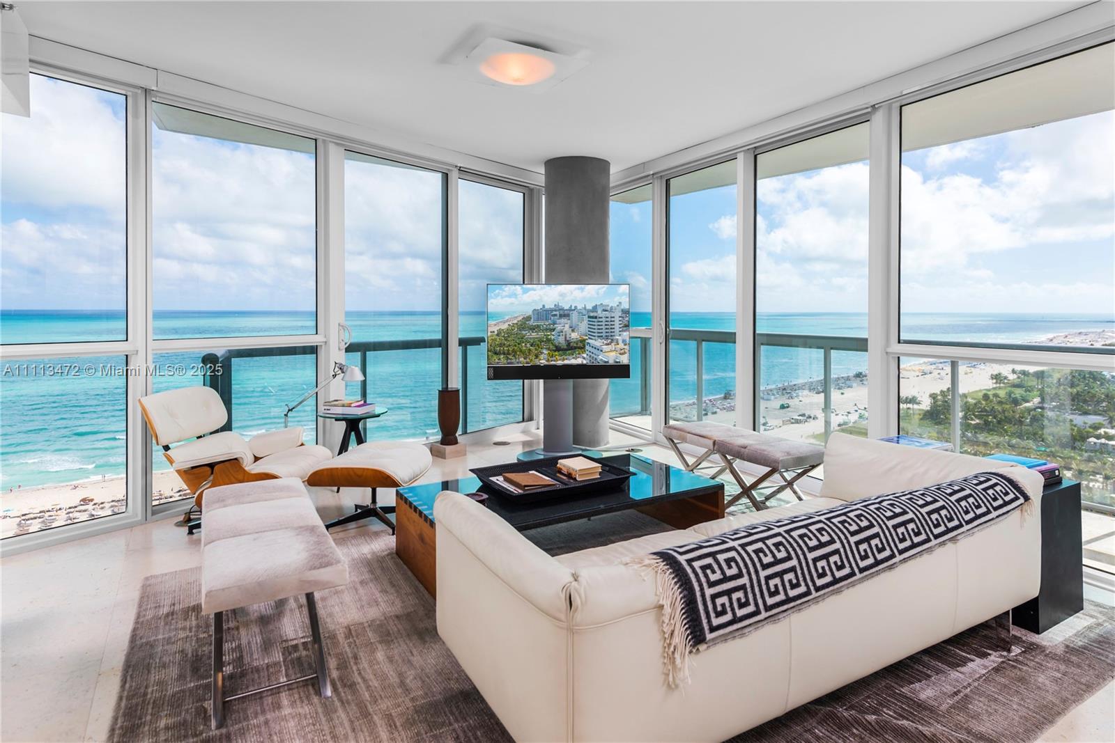 A living room features floor-to-ceiling windows with ocean views, a white sofa, and a lounge chair — 101 20th St # 2208, Miami Beach FL 33139, MIAMI BEACH, FL
