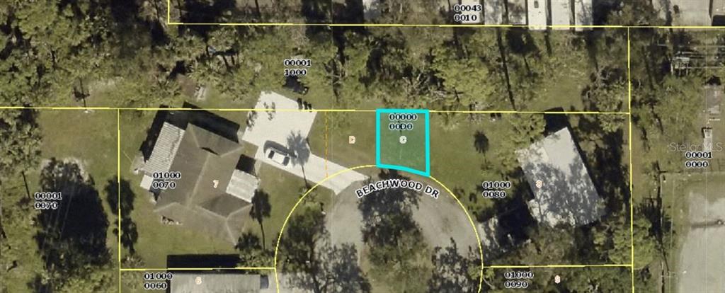 This is an aerial map showing a highlighted vacant lot on a cul-de-sac — 1826 BEACHWOOD DRIVE, NORTH FORT MYERS, FL
