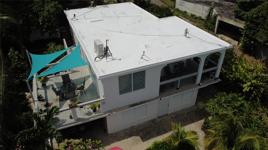 An elevated view of a white two-story house with a flat roof and turquoise shade sails — 645 CASA RINCON, VIEQUES, PR