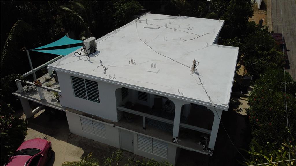 An aerial view shows a two-story white house with a flat roof and a balcony — 645 CASA RINCON, VIEQUES, PR