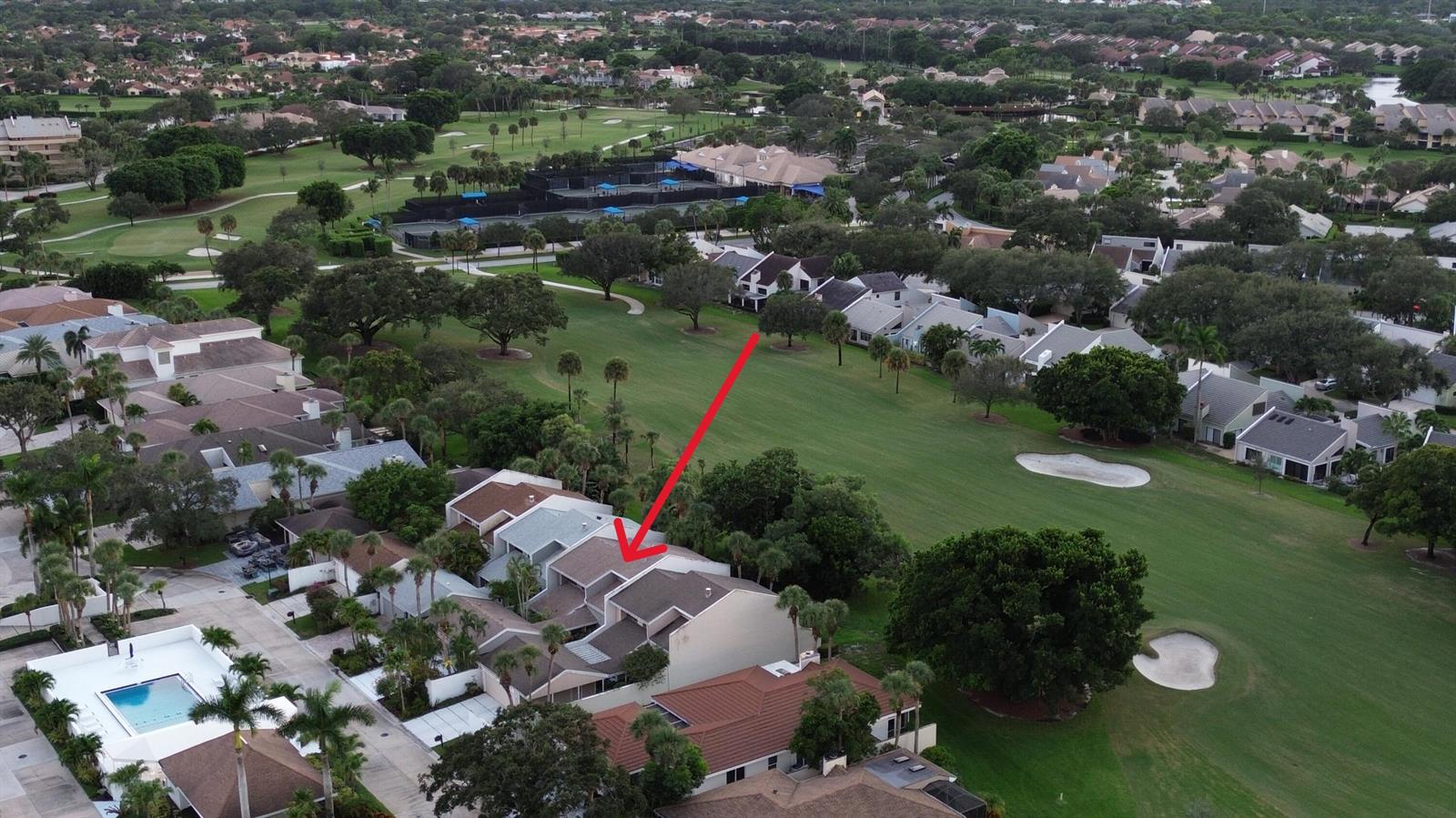 An aerial view shows a multi-story townhouse complex situated next to a golf course — 17145 Bay Street, Jupiter FL 33477, JUPITER, FL