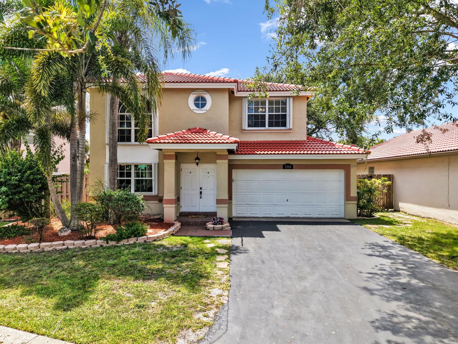 A two-story house with a red tile roof, beige stucco walls, and a two-car garage — 3364 NW 79th Avenue, Margate FL 33063, MARGATE, FL