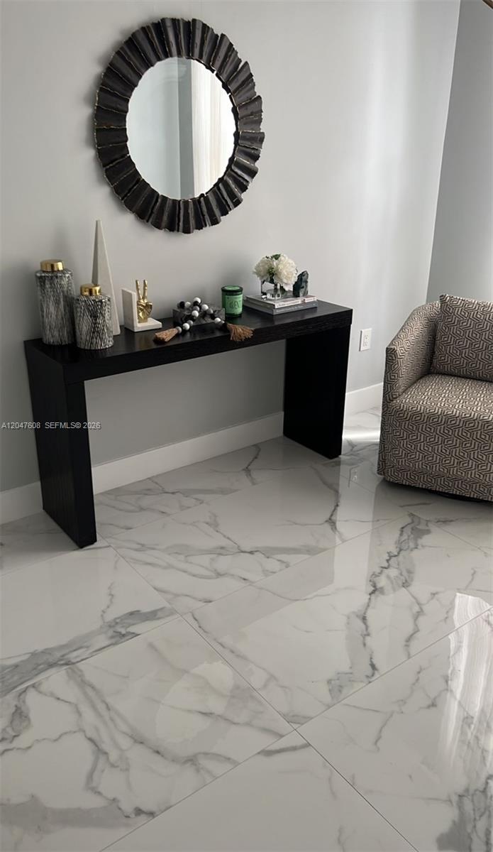 A black console table sits against a gray wall beneath a round decorative mirror — 8715 SW 152nd Ave # 312, Miami FL 33193, MIAMI, FL