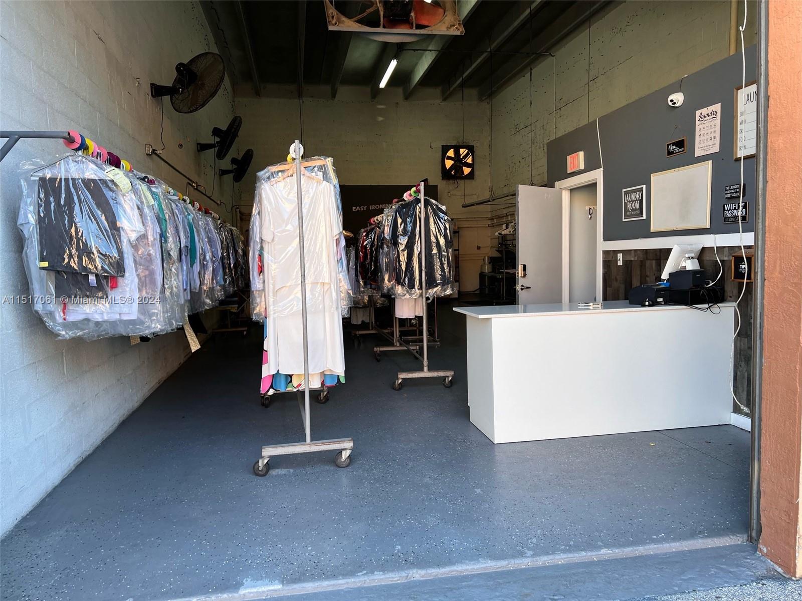 A dry cleaning shop features garment racks, a service counter, and exposed industrial ceiling beams — 8055 W 23rd Ave #2, Hialeah FL 33016, HIALEAH, FL
