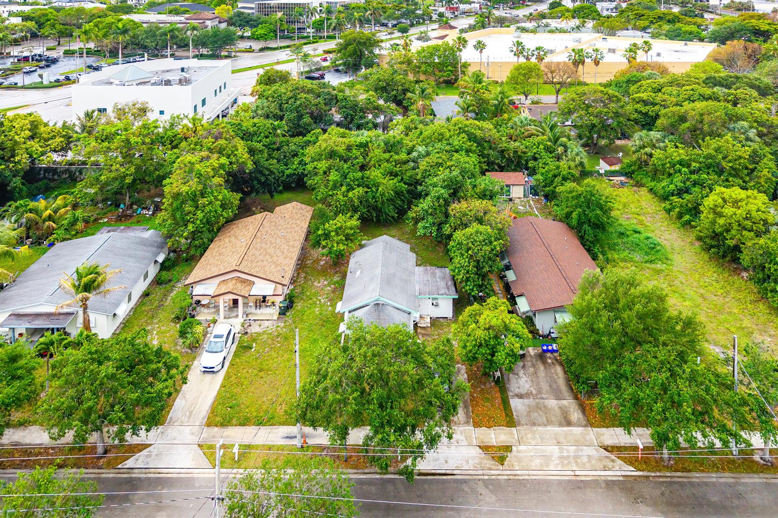 An aerial view shows three residential houses with driveways and trees along a suburban street — 156 Pearl Street, Boca Raton FL 33432, BOCA RATON, FL
