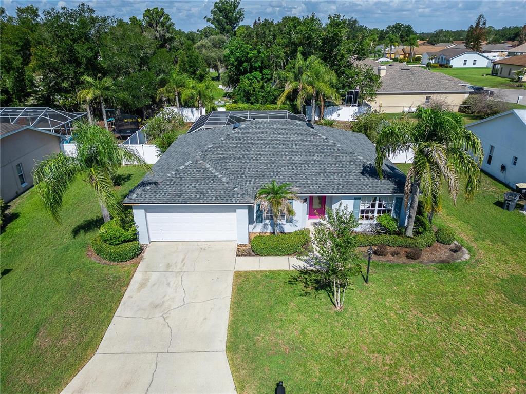 An aerial view of a single-story house with a gray roof, white garage, and palm trees — 692 JESSANDA CIRCLE, LAKELAND, FL