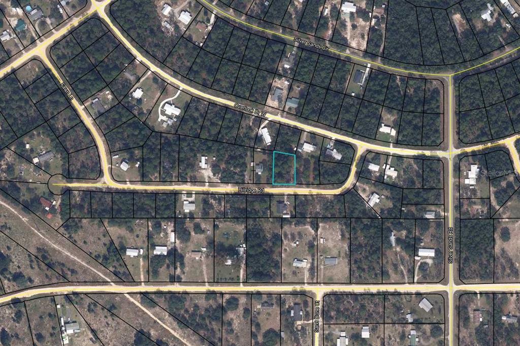 This is an aerial map showing a vacant lot highlighted in blue along a residential road — 5814 HILLRIDGE ROAD, KEYSTONE HEIGHTS, FL