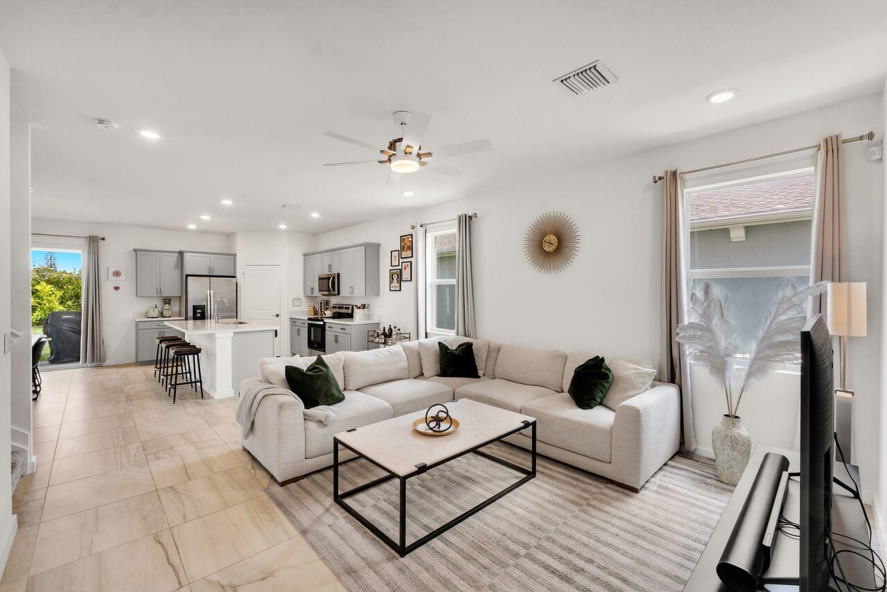 A two-story house with a gray garage, paved driveway, and white vinyl fence — 4506 Catalina Way, FL 33463, FL
