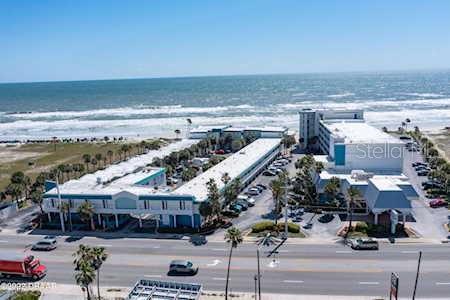 An aerial view shows a multi-story hotel complex situated directly along a sandy beach — 935 S ATLANTIC AVENUE UNIT 364, DAYTONA BEACH, FL