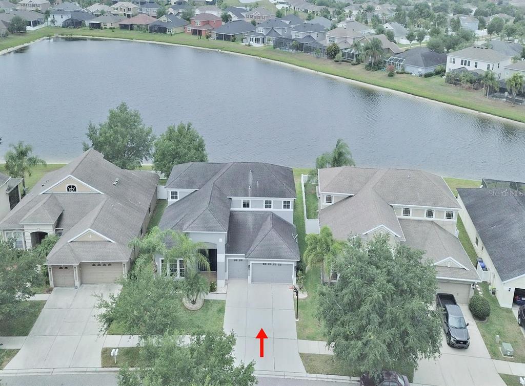 An aerial view of a suburban house with a gray roof and a concrete driveway — 13714 ARTESA BELL DRIVE, RIVERVIEW, FL