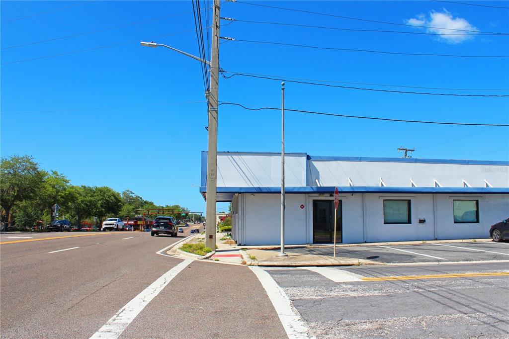 A low-rise commercial building with a white facade sits next to a paved road — 2518 S FLORIDA AVENUE, LAKELAND, FL
