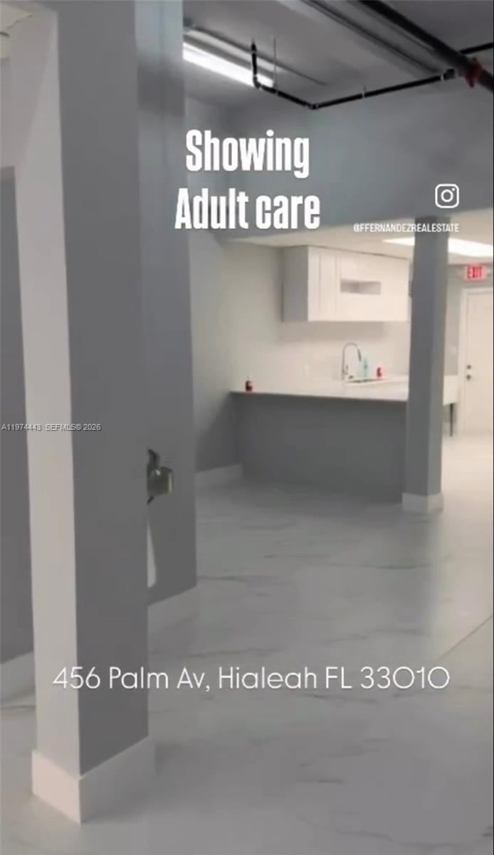 An interior view shows a room with gray walls, white cabinets, and light-colored flooring — Palm Ave, Hialeah FL 33010, HIALEAH, FL